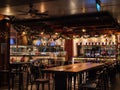 Empty tables with only two customers at MorganfieldÃ¢â¬â¢s American bar and restaurant at Orchard Road, Singapore in the evening. Royalty Free Stock Photo